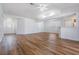 Open-concept living room with new hardwood floors and vaulted ceilings at 29443 Zeller Ave, San Antonio, FL 33576
