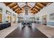 Community lounge area with high ceilings, comfortable seating, plants, and art-decorated walls at 29443 Zeller Ave, San Antonio, FL 33576