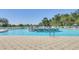 Stunning community pool with a center fountain and plenty of room for relaxation on a sunny day at 29443 Zeller Ave, San Antonio, FL 33576