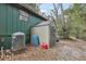 Exterior view of a backyard storage shed with weathered tanks at 303 Grand Ave, Brooksville, FL 34604