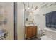 Bathroom features a shower stall, light wood vanity, decorative mirror and inspirational wall art at 303 Grand Ave, Brooksville, FL 34604