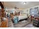 An ample bedroom is equipped with a ceiling fan and a wall-mounted television at 303 Grand Ave, Brooksville, FL 34604