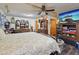 This well-appointed main bedroom has a ceiling fan and a wall-mounted television at 303 Grand Ave, Brooksville, FL 34604