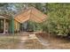 Exterior shot of a carport on a property surrounded by lush greenery at 303 Grand Ave, Brooksville, FL 34604