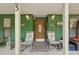 Charming front porch featuring rocking chairs and welcoming decor at 303 Grand Ave, Brooksville, FL 34604