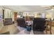Spacious living room featuring seating, a large TV, and stairs at 303 Grand Ave, Brooksville, FL 34604