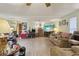 Large living room featuring a large TV, lots of seating, and stairs at 303 Grand Ave, Brooksville, FL 34604