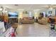Spacious living room featuring a large TV, comfortable seating, and ceiling fan at 303 Grand Ave, Brooksville, FL 34604