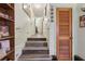A stairwell provides access to other parts of the home. The walls are light and display decorative adornments at 303 Grand Ave, Brooksville, FL 34604