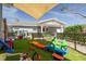 -friendly backyard with play area and artificial turf, creating a safe and fun environment at 305 6Th Sw Ave, Largo, FL 33770