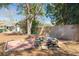 Serene backyard featuring a stone fire pit and mature trees, ideal for outdoor gatherings at 305 6Th Sw Ave, Largo, FL 33770