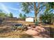 Large backyard features fire pit and mature trees, perfect for entertaining and relaxing outdoors at 305 6Th Sw Ave, Largo, FL 33770