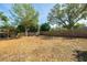 Expansive backyard with mature trees and a wooden fence, offering privacy and space for recreation at 305 6Th Sw Ave, Largo, FL 33770