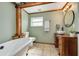 Bathroom featuring a claw foot tub, a rustic vanity, and green walls at 305 6Th Sw Ave, Largo, FL 33770