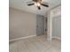 Bedroom with grey walls, tile flooring, closet access, and a grey door at 305 6Th Sw Ave, Largo, FL 33770