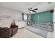 Bedroom with a neutral color scheme, ceiling fan, and a teal accent wall at 305 6Th Sw Ave, Largo, FL 33770