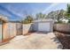 Detached one car garage with a large driveway and wooden fence at 305 6Th Sw Ave, Largo, FL 33770