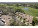 Scenic aerial view of the homes situated near lush greenery, a pond, and a golf course at 3130 Eagles Landing W Cir, Clearwater, FL 33761
