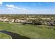 Scenic aerial view of a community with lush green golf course and nearby residential buildings at 3130 Eagles Landing W Cir, Clearwater, FL 33761