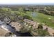 High aerial showcasing the neighborhood with a golf course, several ponds, and lush landscaping at 3130 Eagles Landing W Cir, Clearwater, FL 33761