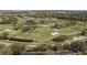 Expansive aerial shot of a verdant golf course featuring multiple sand traps and tranquil water hazards at 3130 Eagles Landing W Cir, Clearwater, FL 33761