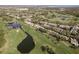 Sprawling golf course community with lush green fairways, ponds, and neatly arranged townhome properties at 3130 Eagles Landing W Cir, Clearwater, FL 33761