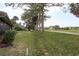 Backyard landscaping with a view of the golf course and manicured lawn at 3130 Eagles Landing W Cir, Clearwater, FL 33761