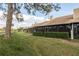Rear exterior showing the screened patios and the manicured landscaping at 3130 Eagles Landing W Cir, Clearwater, FL 33761