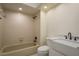 Cozy bathroom featuring tan tile shower, white cabinets, and marble countertops at 3130 Eagles Landing W Cir, Clearwater, FL 33761