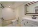 Updated bathroom featuring a white tile shower-tub combo and modern vanity with bronze fixtures at 3130 Eagles Landing W Cir, Clearwater, FL 33761