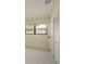 Bedroom featuring a neutral color palette, large window, and closet at 3130 Eagles Landing W Cir, Clearwater, FL 33761