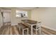 Dining room with a dark wood table and bench visible to the kitchen through opening at 3130 Eagles Landing W Cir, Clearwater, FL 33761