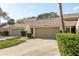 Exterior of the home with a two-car garage and well-manicured landscaping at 3130 Eagles Landing W Cir, Clearwater, FL 33761