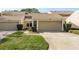 Well-maintained townhome featuring a private garage, mature landscaping, and a welcoming entrance at 3130 Eagles Landing W Cir, Clearwater, FL 33761