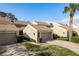 Charming townhome featuring well-maintained landscaping, a private garage, and an inviting entrance at 3130 Eagles Landing W Cir, Clearwater, FL 33761