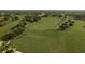 Aerial view of a sprawling golf course with lush green fairways and manicured greens, dotted with trees and golfers at 3130 Eagles Landing W Cir, Clearwater, FL 33761