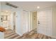 Hallway with wood floors leading to the main entrance and a bathroom at 3130 Eagles Landing W Cir, Clearwater, FL 33761