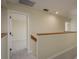 Bright hallway with neutral walls, wood trim, and carpeted floors leads to the bedroom at 3130 Eagles Landing W Cir, Clearwater, FL 33761