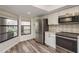 Bright kitchen with stainless steel refrigerator, range, microwave, granite counters and window at 3130 Eagles Landing W Cir, Clearwater, FL 33761