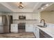 Modern kitchen featuring stainless steel appliances, white cabinets, and stylish backsplash at 3130 Eagles Landing W Cir, Clearwater, FL 33761