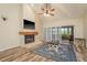 Inviting living room with a brick fireplace, wood floors, and sliding doors at 3130 Eagles Landing W Cir, Clearwater, FL 33761