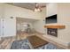 Bright living room with a ceiling fan, fireplace, dining area and view into the updated kitchen at 3130 Eagles Landing W Cir, Clearwater, FL 33761