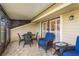 Outdoor patio with comfortable wicker furniture and a view into the sunroom at 3130 Eagles Landing W Cir, Clearwater, FL 33761