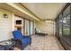 Sunroom patio with comfortable furniture and views of the exterior of the home at 3130 Eagles Landing W Cir, Clearwater, FL 33761