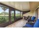 Enjoy outdoor living in this screened porch with peaceful views of a golf course at 3130 Eagles Landing W Cir, Clearwater, FL 33761