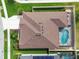 Aerial view of the property showcases the house, pool, screened-in patio and landscaping at 32484 Worden Pass, Wesley Chapel, FL 33543