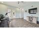 A bonus room with wooden-look tile, TV, and french doors at 32484 Worden Pass, Wesley Chapel, FL 33543