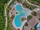 Aerial view of a resort-style community pool with palm trees and lounge chairs at 32484 Worden Pass, Wesley Chapel, FL 33543