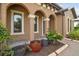 Charming front porch with stone accents, decorative plants, and an inviting walkway at 32484 Worden Pass, Wesley Chapel, FL 33543