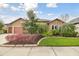 Charming home with a well-manicured lawn, mature landscaping, and inviting entrance, creating a welcoming atmosphere at 32484 Worden Pass, Wesley Chapel, FL 33543